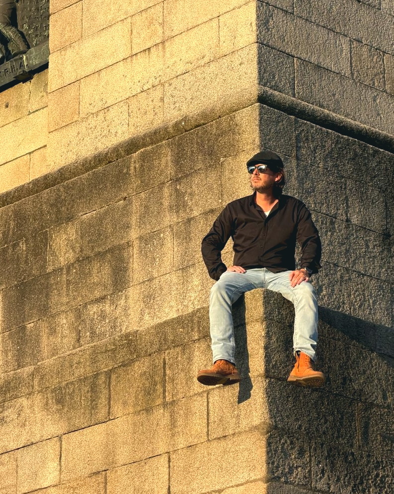 Adam Grumbo at a stone monument